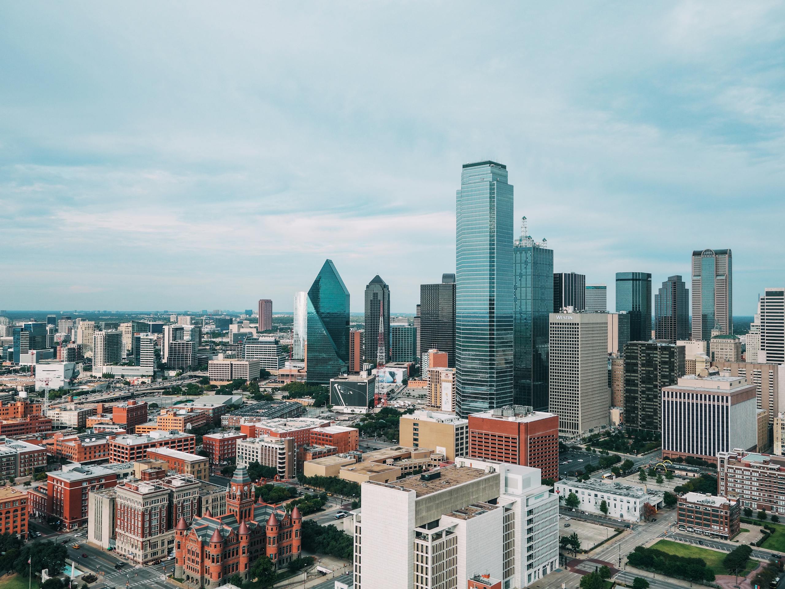 Aerial view of the vibrant Dallas skyline with iconic skyscrapers and urban landscape.